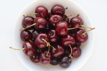 Fresh cherries in white bowl isolated
