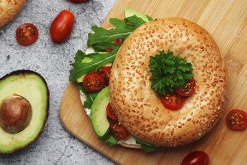 Sesame bagels with tomatoes and avocado