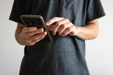 Close-up of unrecognizable young man using his phone