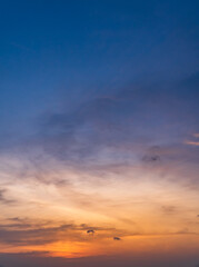 Dusk sky vertical in the evening on twilight with colorful orange sunlight on dark blue sky