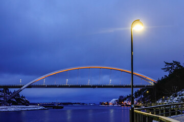Stockholm, Sweden  The arched Svindersvik bridge at night.