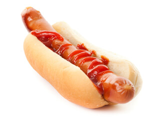 One single hot dog with ketchup in a white bun. Studio photo isolated on white background.