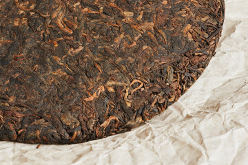 Chinese pressed pu er tea on wrapping paper close up