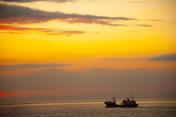 Fototapeta na wymiar Sunset at at the fishing harbour around the sea coast