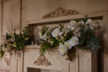 Fototapeta na wymiar Fireplace with candles decorated with flowers