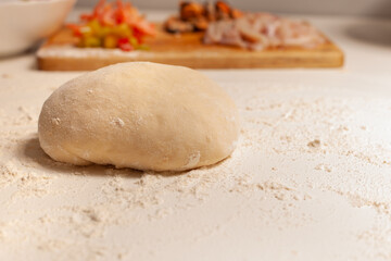 Preparation of the dough for pizza. Hands prepare the dough