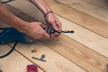 close up of a worker clamps a drill into a drill