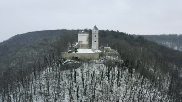 The fairy tale castle Plesse in winter with a huge amount of snow on a beautiful mountain near Bovenden, Germany, Europe.