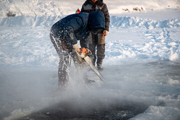 preparing an ice hole for swimming