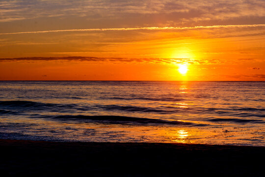 Beach sunrise over waves with clouds, Garden City Beach, South Carolina
