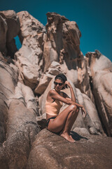 Young beautiful woman having fun in water at beach. Summer photo of young beautiful girl in sea swimming and having fun. Female on beach enjoying sea vacation traveling