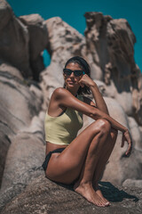Young beautiful woman having fun in water at beach. Summer photo of young beautiful girl in sea swimming and having fun. Female on beach enjoying sea vacation traveling