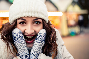 Young pretty surprised shocked smiling amazement open mouth white teeth woman face shouting screaming looking at the camera. New Year Christmas decorations, Valentines Day concept.

