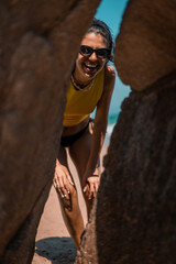 Young beautiful woman having fun at beach. Summer photo of young beautiful girl. Female on beach enjoying sea vacation traveling