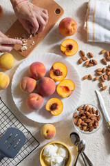 Grilled peaches summer dessert American bbq. Served with almonds, ice cream and cookie crumbs. top view