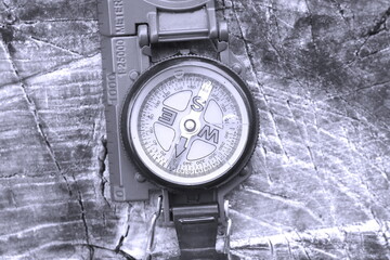 round compass on natural wooden background as symbol of tourism with compass, travel with compass and outdoor activities with compass