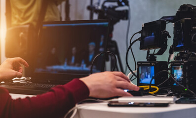 tv director sits at the remote control on the set