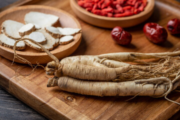 Fototapeta na wymiar Ginseng, wolfberry and jujube are in the wooden plate