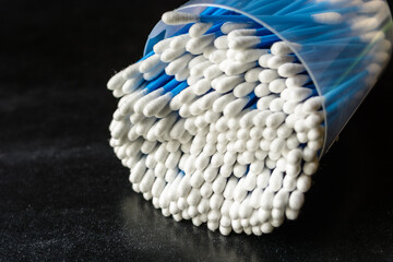 cotton swabs for ears in a round plastic packaging on a table
