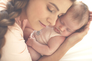 Obraz na płótnie Canvas Portrait of a beautiful mother, with her nursing baby. High quality photo.