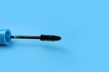 Mascara brush on blue background