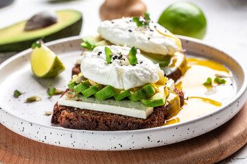 Healthy Breakfast with Wholemeal Bread Toast and Poached Egg avocado and microgreen for healthy breakfast or snack. Restaurant menu, dieting, cookbook recipe