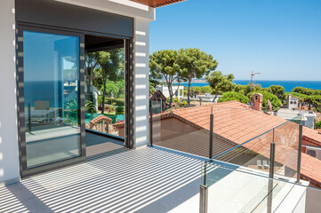 Empty room with large panoramic windows overlooking the sea. Room after major renovation. 