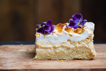 Lemon meringue cake slice with crispy lemon zest