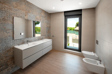 Fototapeta na wymiar Modern bathroom with luxury tiles. Large shower . Custom furniture.