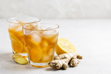 Festive summer drink, iced lemon ginger tea in glasses. Space for text.