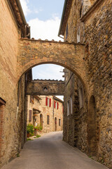 Obraz na płótnie Canvas The historic arched entrance to the medieval village of San Lorenzo a Merse near Monticiano in Siena Province, Tuscany, Italy 