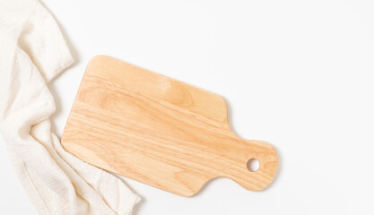 Brown wood cutting board with a napkin on the top table, top view