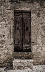 An old door in the historic medieval village of Semproniano in Grosseto Province, Tuscany, Italy
