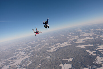 Skydiving. Funny jump. A man and a woman are having fun in the sky.