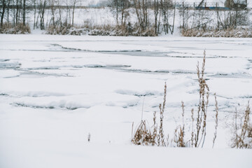 Winter frosty landscape of the river with broken ice