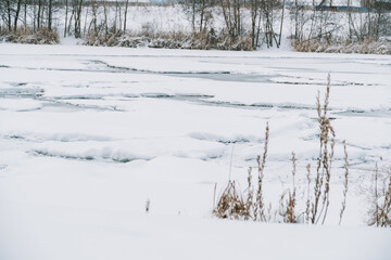 Winter frosty landscape of the river with broken ice