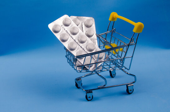 Photo of a small cart from a supermarket with pills. Buying pills.
