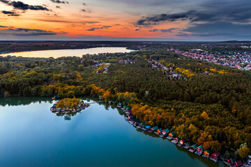 Tata, Hungary - Aerial drone view from high above the beautiful Lake Derito (Derito-to) in October with small fishing island. Old Lake (Oreg-to), colorful sunset and the city of Tata at background
