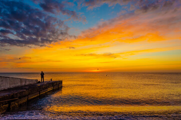 Fisherman on the pier at sunrise.