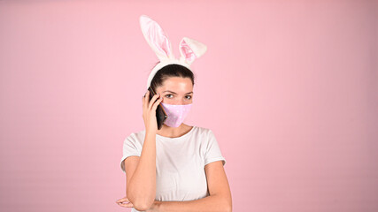 Obraz na płótnie Canvas Girl with ears in a mask with a phone