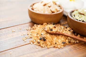 Composition of spa treatment. Natuaral cosmetics with pink himalayan spa salt. Sea bath salt for spa relaxation on wooden background..