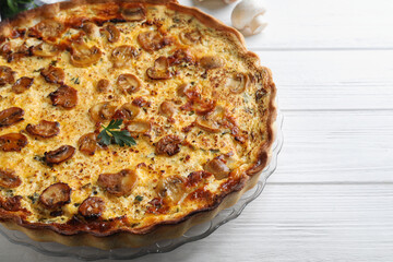 Delicious homemade mushroom pie on white wooden table, closeup