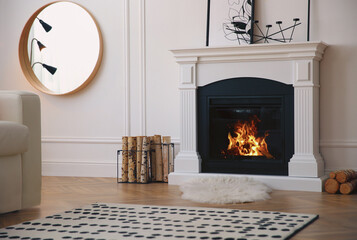 Modern fireplace with burning wood in room. Interior design