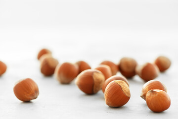 Close-up of hazelnuts on a light background.