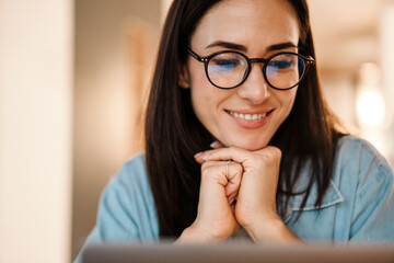 Attractive young smart woman working on laptop