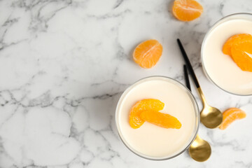 Delicious tangerine jelly on white marble table, flat lay. Space for text