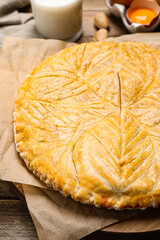 Traditional galette des rois on wooden table, closeup