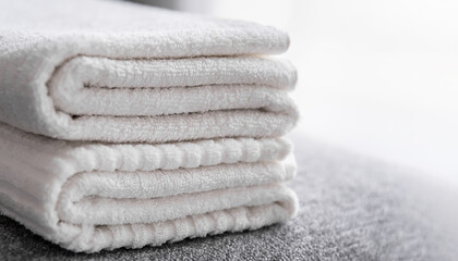 Fototapeta na wymiar Hotel staff, fresh white bath towels on the bed. Room cleaning service.