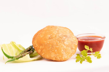 Indian Khasta Masala Kachauri Also Called Pyaj Kachori Or Pyaaz Kachodi Stuffed With Urad Daal Or Moong Mung Dal Served With Tomato Chutney. Low Angle Front View. White Background With Space For Text