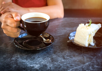 Young woman sitting in coffee shop at table, Female drinking coffee and using smartphone working with a tablet, Concept of business.